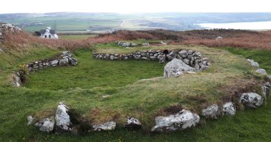The image shows one of the stone hut circles in Holyhead, Anglesey.
