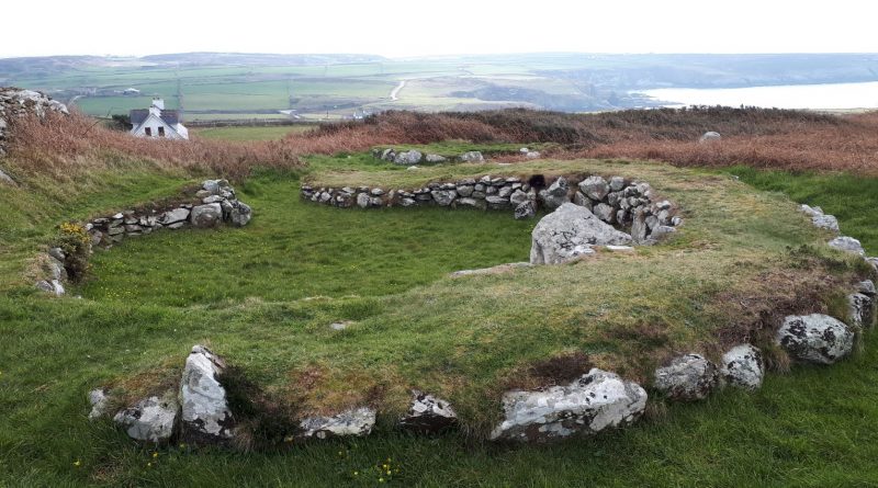 The image shows one of the stone hut circles in Holyhead, Anglesey.